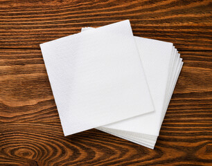 White paper napkins on a wooden background.