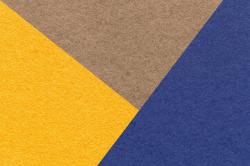 Fototapeta premium Texture of craft yellow, brown and navy blue shade color paper background, macro. Vintage abstract cardboard