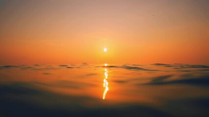 Slow Motion ocean surface from underwater at sunset with rays of light. Crystal clear breaking ocean wave with waving waterline. Sunrise over calm sea. Dawn over horizon, ocean, water - timelapse or - Powered by Adobe