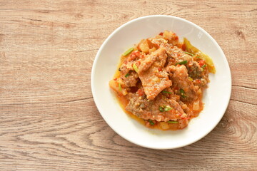 deep fried slice mango fish with pineapple and chili in sweet sour sauce on plate