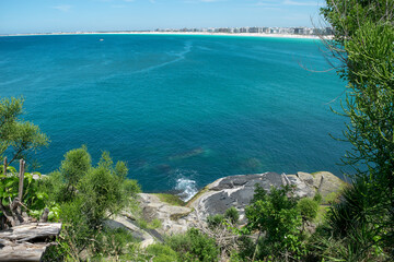 Beaches of the fort around Fort São Mateus in Cabo Frio, with many rocks and the blue sea water running between them.