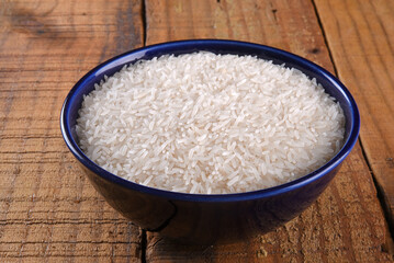 white rice natural long rice grain in porcelain bowl use texture background