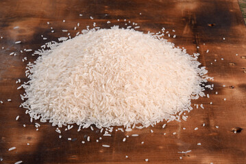 white rice natural long rice grain on wooden table use texture background