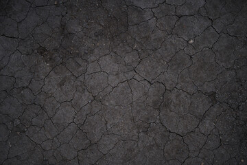 Dry cracked earth, cracks, earth in the sun, black earth, natural background with copy space. High quality photo