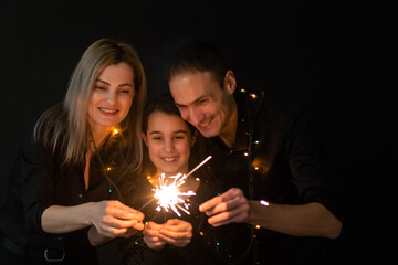 family with garland on a black background