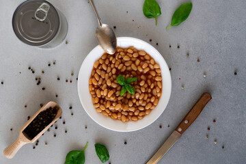 Baked Beans in tomato sauce in a plate against a grey background. Food. Food background. Top view