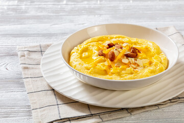 corn grits with butter, vegan cheese, and almonds