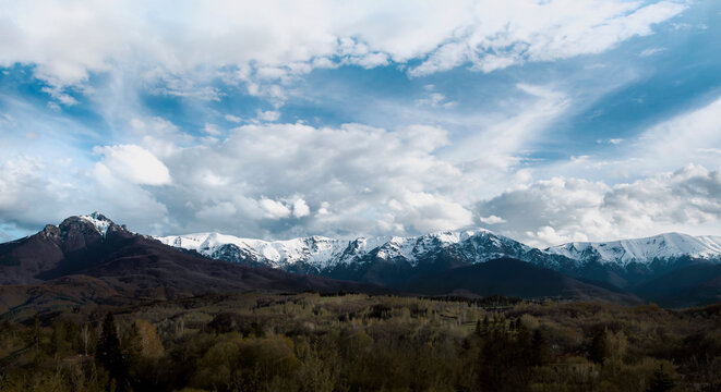 Landscape with mountain, clouds and a forest