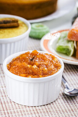 Brazilian pumpkin jam or pudding, with candied pumpkin jam in the background, tradition of the Brazilian June festivals