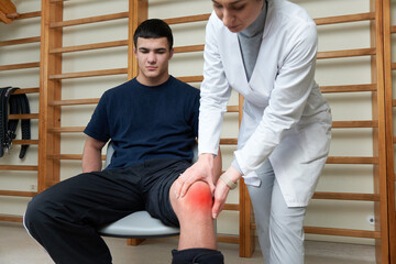 Doctor examines a patient after an injury. Medical interview,  support, injury treatment after...