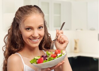 Diet concept, young woman eat vegetables salad