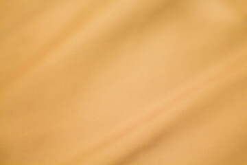 Gold color smooth luxury silk or cotton texture with waves for background wallpaper.