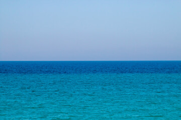 Horizonte sobre un mar de aguas azul y verde turquesa. Canal de Otranto que conecta el mar Jónico y el mar Adriático visto desde Otranto en un día luminoso de verano.