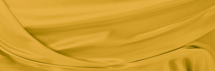 yellow gold satin texture that is white silver fabric luxurious shiny that is abstract silk cloth background with patterns soft waves blur beautiful.