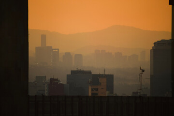 sunset over a orange foggy city landscape