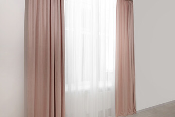 Fototapeta na wymiar Elegant window curtains and white tulle indoors. Interior design
