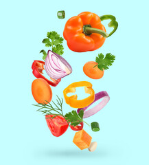 Spice mix for cooking. Set of falling fresh vegetables and herbs on light blue background