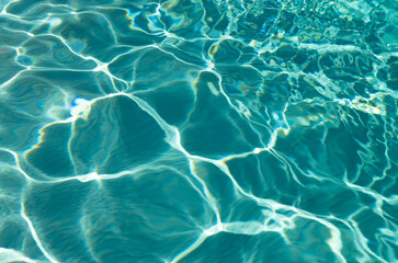 defocused turquoise water summertime background with ripples. defocused turquoise ripple water