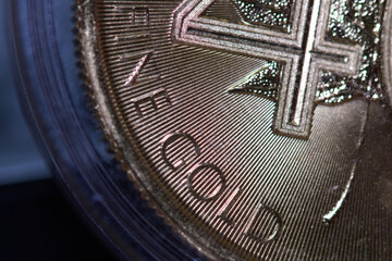 Macro Photo of a Gold Coin, selective focus on Fine Gold description.