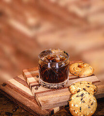 Irish coffee in drinking glass on wooden surface