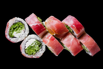 sushi roll with cream cheese jamon salad on a black mirror background