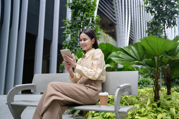 A young businesswoman is working in modern city downtown of Singapore