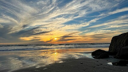 Wispy cloud sunset over beach in Los Angeles, CA