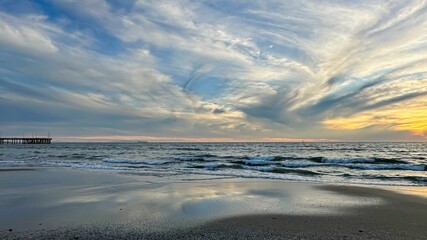 Fototapeta na wymiar Wispy cloud sunset over beach in Los Angeles, CA