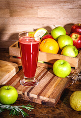 Fresh beetroot smoothie, beet, arugula and lettuce leaves on dark wooden background