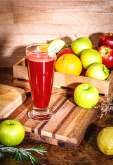 Fresh beetroot smoothie, beet, arugula and lettuce leaves on dark wooden background