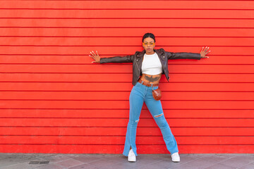 urban girl in the street on red background wall