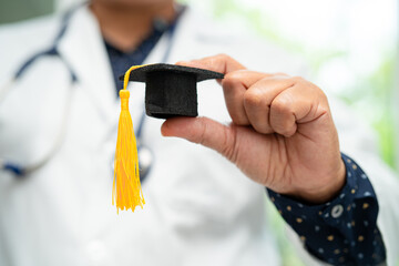 Asian doctor study learn with graduation gap hat in hospital ward, clever bright genius education...