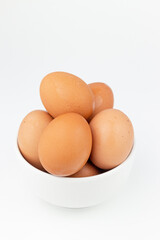 Eggs in white bowl isolated on white background with clipping path