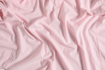 Crumpled pink fabric as background, top view