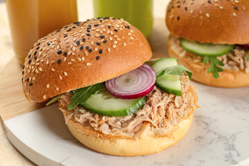 Delicious sandwiches with tuna and vegetables on serving board, closeup