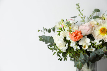 Bouquet of beautiful flowers in vase on white background, closeup. Space for text