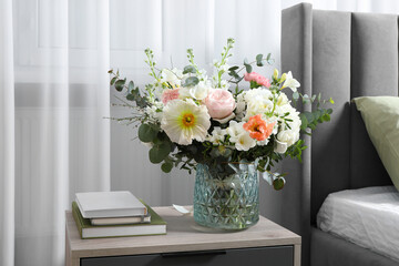 Bouquet of beautiful flowers on bedside table indoors