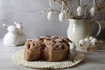 Delicious Italian Easter dove cake (Colomba di Pasqua) and festive decor on white wooden table