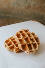 waffles sit on top of a plate in the kitchen