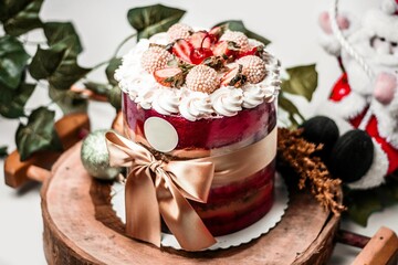 a cake sitting on a wooden piece on a table next to some decorating