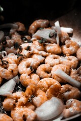 shrimp and onion are cooking in the skillet of a pan