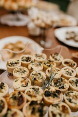 Wooden table is set with a variety of colorful dishes, ready to be enjoyed