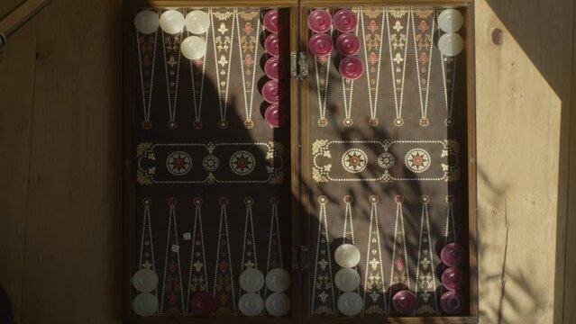 playing backgammon during beautiful sunshine, both players kick each other out, 4k footage.