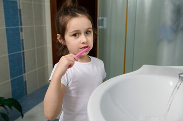 Morning daily routine concept. Dental care and oral hygiene for healthy white baby teeth. Adorable...