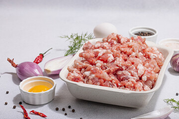 Raw minced meat, spices and herbs. Traditional ingredients for cooking cutlets or meatballs