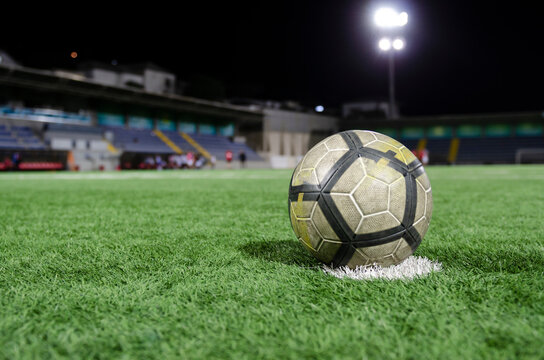 Close-up photo of ball on the penalty kick point of the football field