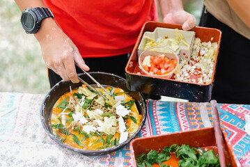 Vegan pizza, hand holding a tray of cube sliced tomatoes for cooking, organic lifestyle and vegan concept.