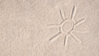 Sand background. Simple image of sun drawn on sand. Sandy beach. Blank negative space for copy.