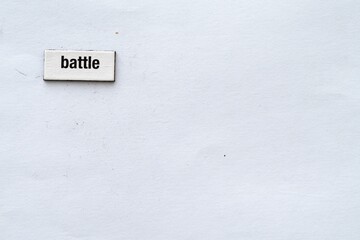 The word battle written on white background with fridge magnet