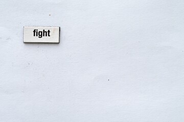 The word fight written on white background with fridge magnet